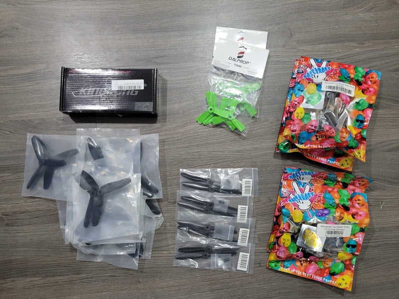 RC drone propeller set, black bi-blade and tri-blade props in multiple sealed packs