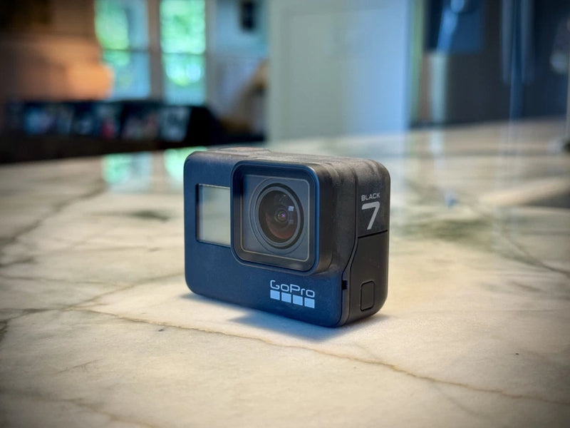 GoPro Hero7 Black action camera with front lens and status screen, dark blue housing