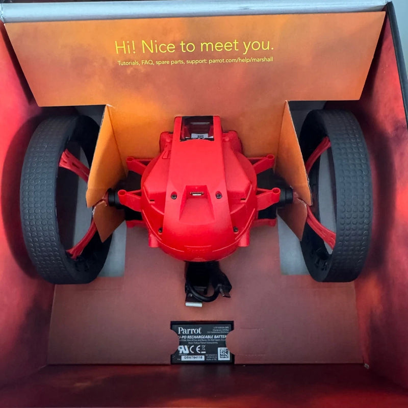 Red mini jumping night drone toy with four prop arms, in open box