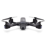 Quadcopter drone with gray body, black arms, front camera pod, and four propellers