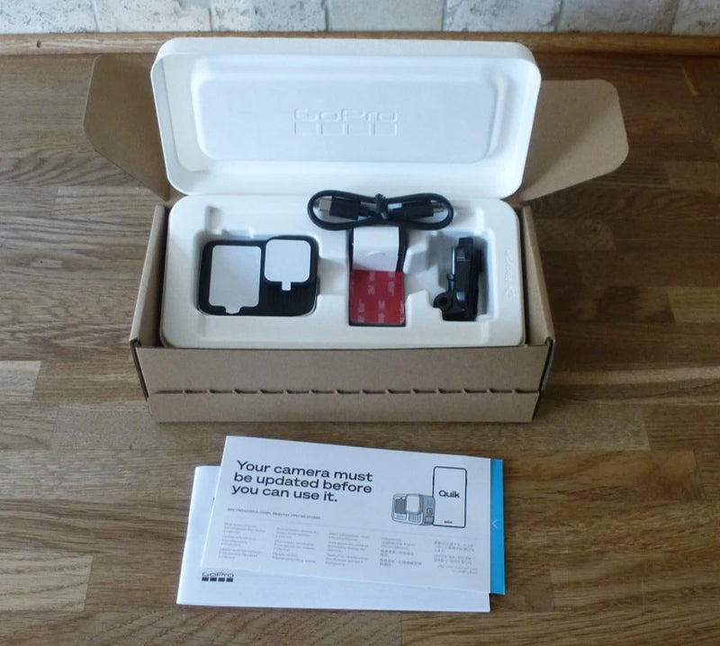 GoPro HERO13 action camera in open case with mounts and cables