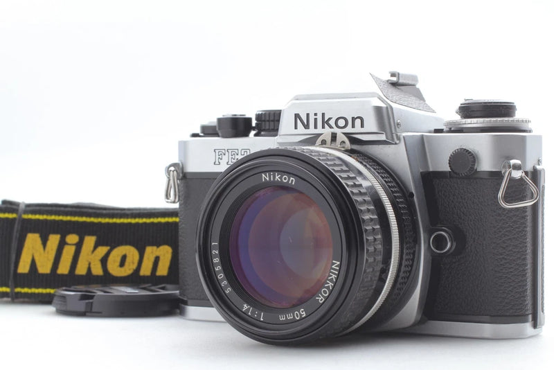 Silver Nikon FE2 35mm film camera with black 50mm lens front