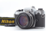 Silver Nikon FE2 35mm film camera with black 50mm lens front