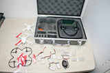 FPV quadcopter drone kit in open case with controller, batteries, and accessories