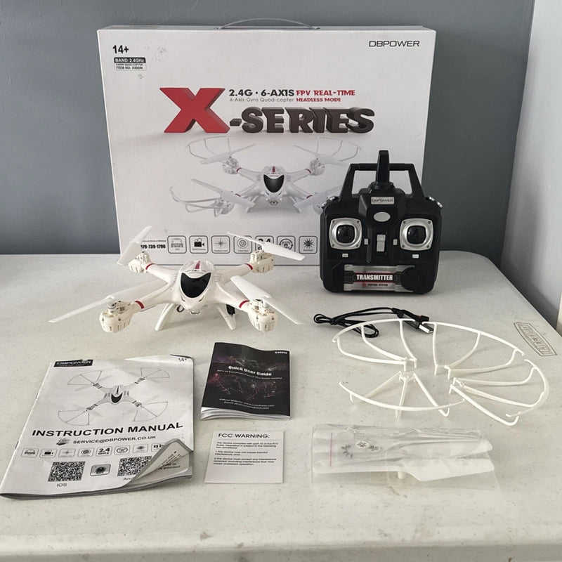 White quadcopter drone kit with black controller, manuals, and accessories