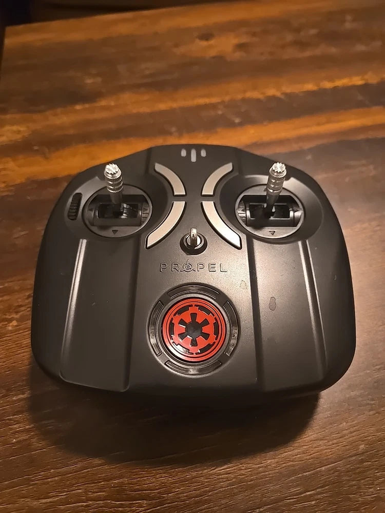 Black Propel remote controller with two joysticks and central emblem
