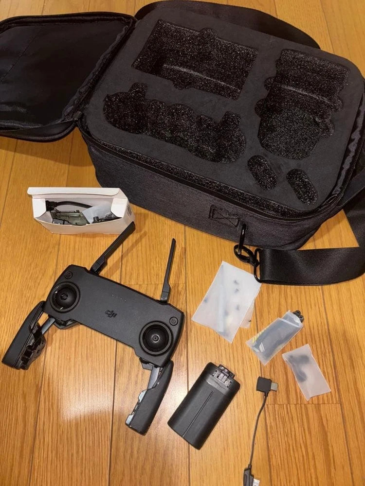 Drone accessories kit with black carrying case and spare batteries
