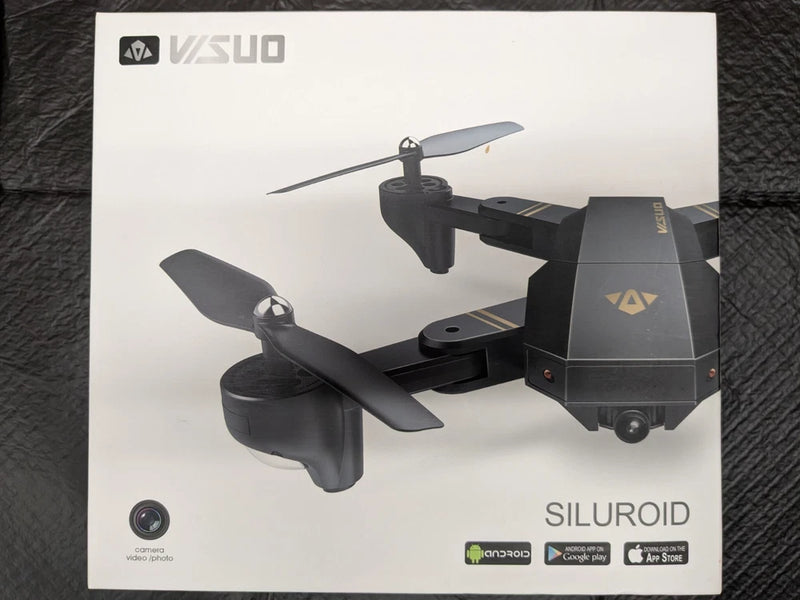 Black quadcopter drone with camera and folding propellers