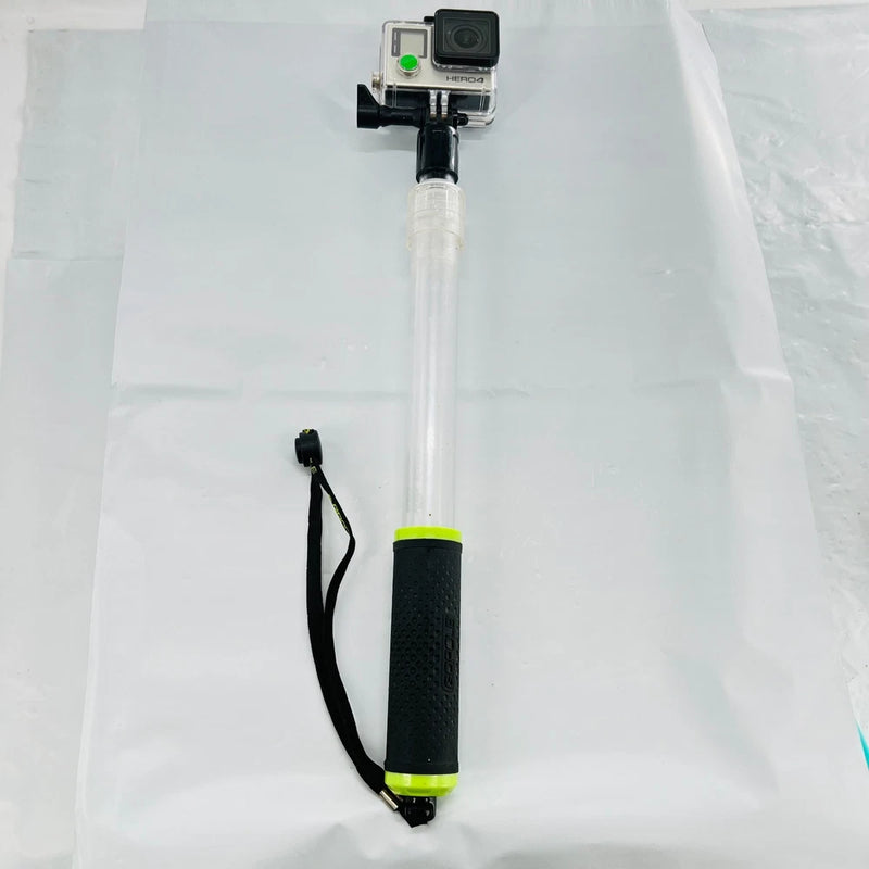 GoPro HERO4 action camera on white extension pole with black grip