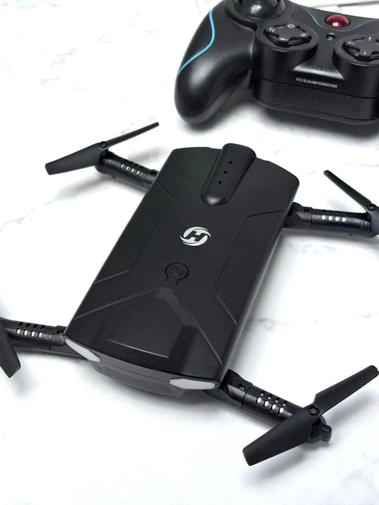 Black mini FPV foldable quadcopter drone with four propellers extended