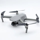 DJI Mavic Air 2 drone with four propellers, gray body and rear camera gimbal