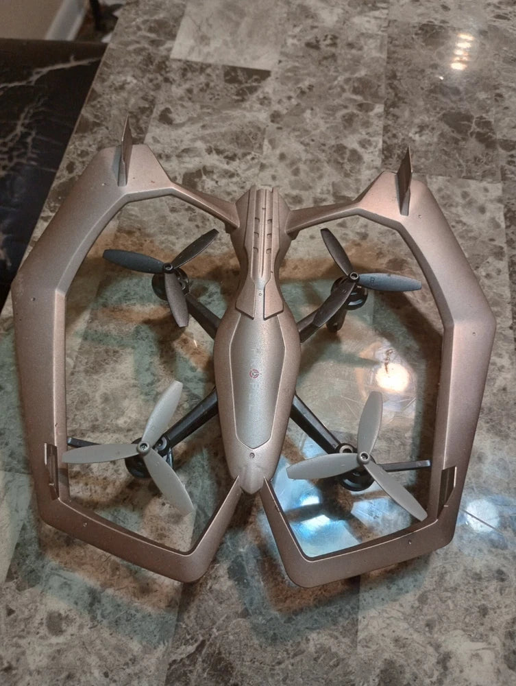 Gray quadcopter drone with four propellers on an open hexagonal frame