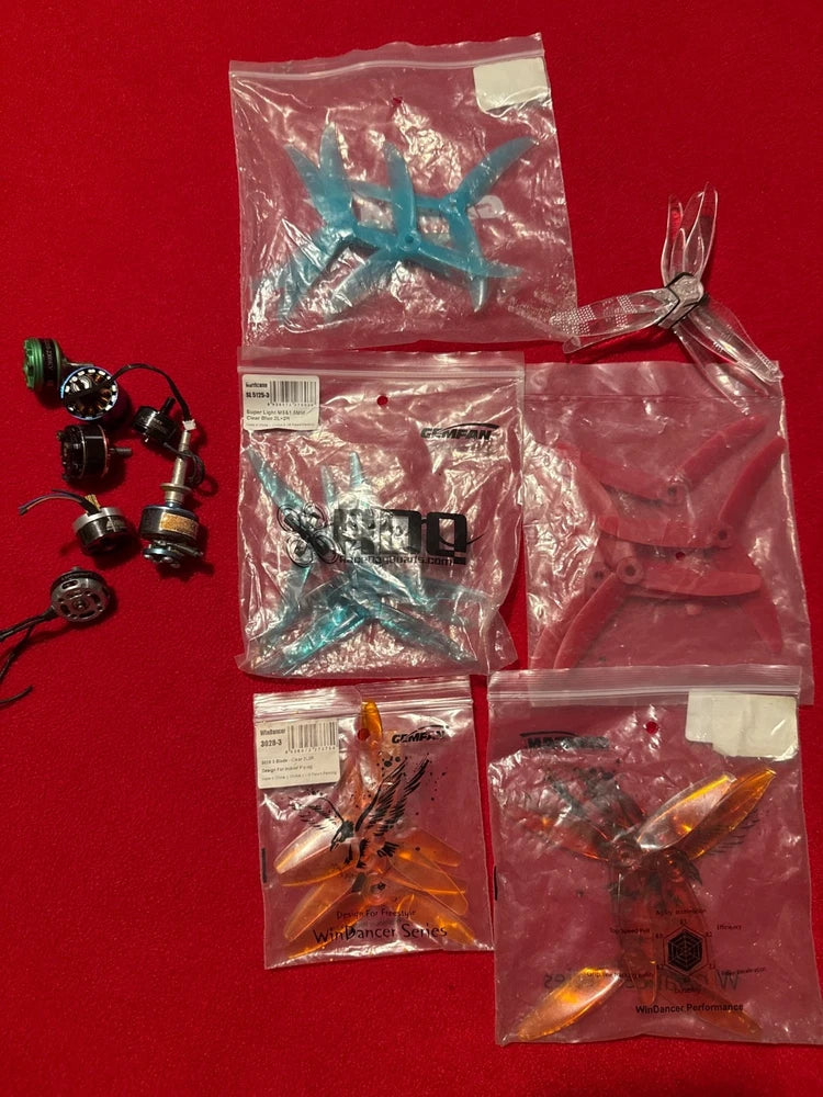 Sealed bags of drone FPV propellers and small motors with mounting hardware