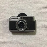 Canon compact 35mm film camera with black leatherette grip and metal lens ring