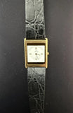 Square gold-tone wristwatch with white dial, Roman numerals, black leather strap