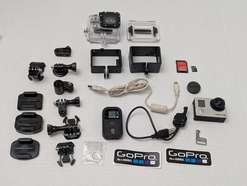 GoPro HERO3 action camera kit with mounts, waterproof case, battery, and memory card