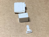 Scale model battery and latch parts, light gray and white plastic pieces