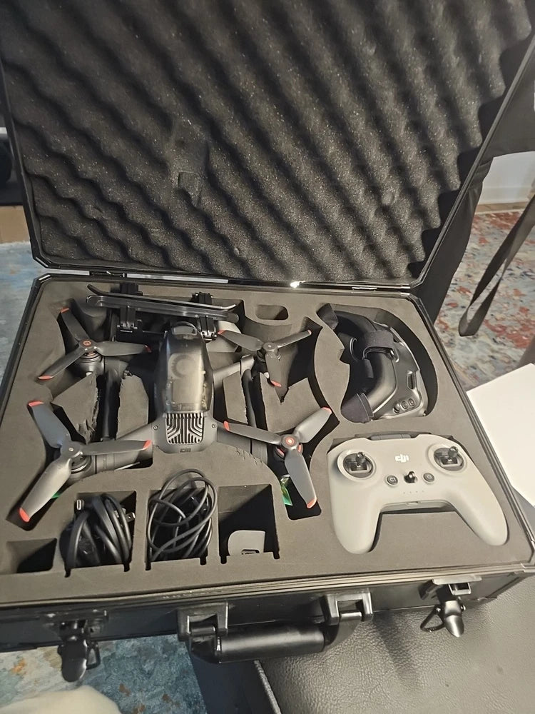FPV drone kit in open hard case with controller, propellers, antennas