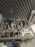 FPV drone kit in open hard case with controller, propellers, antennas