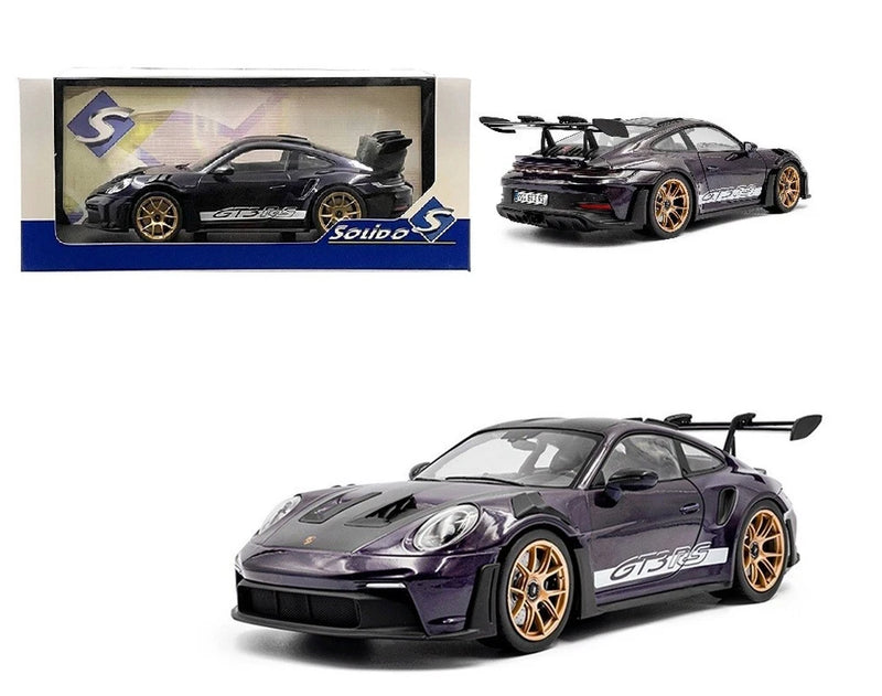 Die-cast sports car model in purple/black with gold wheels, front 3/4 view.