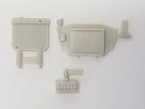 Light gray plastic car engine detail parts: radiator, hose, battery, and mounting pieces