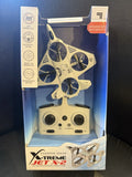 White remote control drone with four propellers, shown in retail box