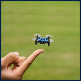 Mini foldable quadcopter drone with camera, held above ground