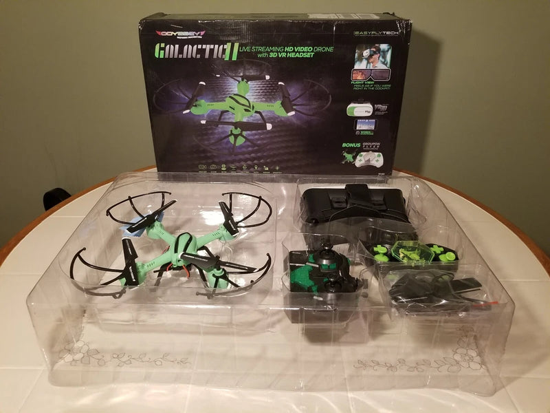Mini quadcopter drone set with green propellers in clear plastic packaging