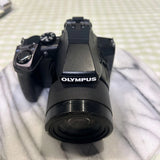 OLYMPUS compact digital camera with large front lens and top dot-sight window, black