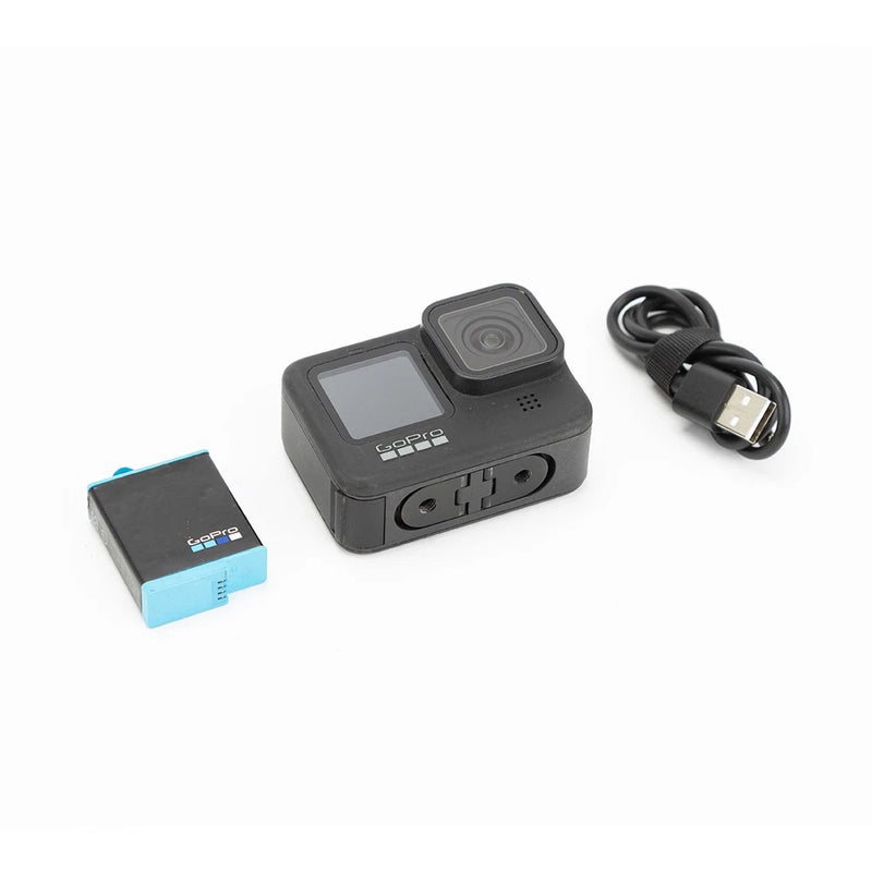 GoPro HERO9 Black action camera with lens, battery, and USB charging cable