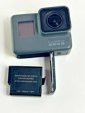 Black GoPro action camera with front lens and detached battery pack