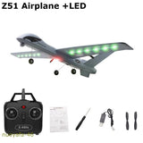 Gray RC glider airplane with green LED lights, 2.4GHz remote controller and accessories