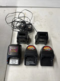 RC battery charger with six black battery packs, labeled 9.6V and caution notices