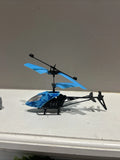 Blue and black RC helicopter toy with spinning rotor blades