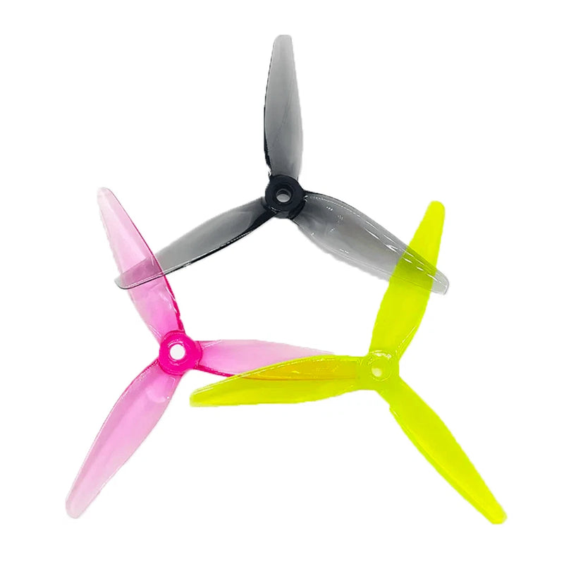 Tri-blade FPV drone propellers with pink, yellow-green, and gray blades