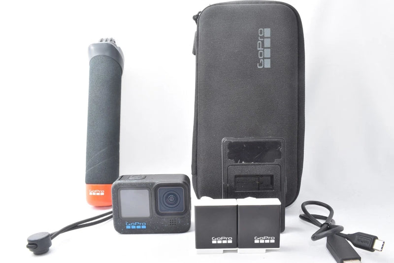 GoPro action camera accessory kit with camera, gray case, handle grip, cables