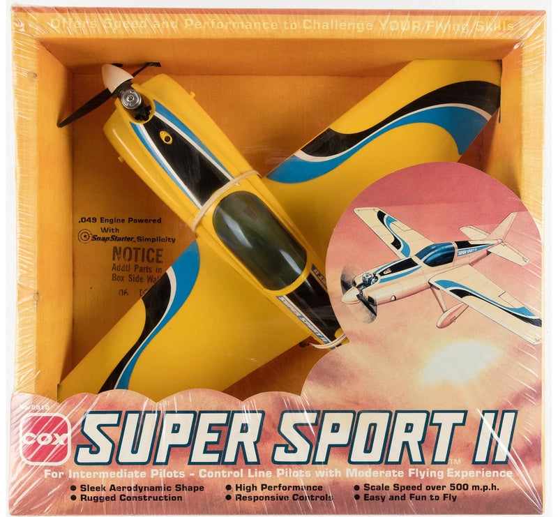Factory-sealed model plane kit with yellow and blue detail, cockpit and propeller visible.
