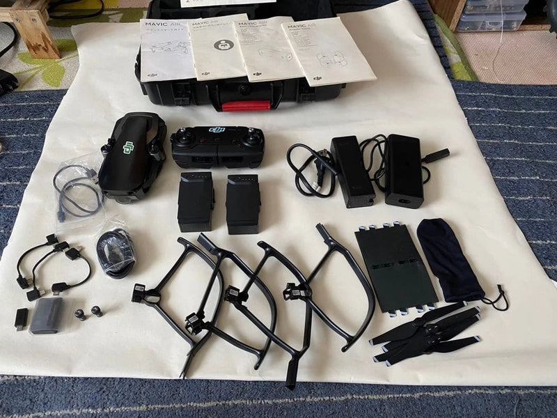 Compact foldable drone quadcopter with controller and charging accessories