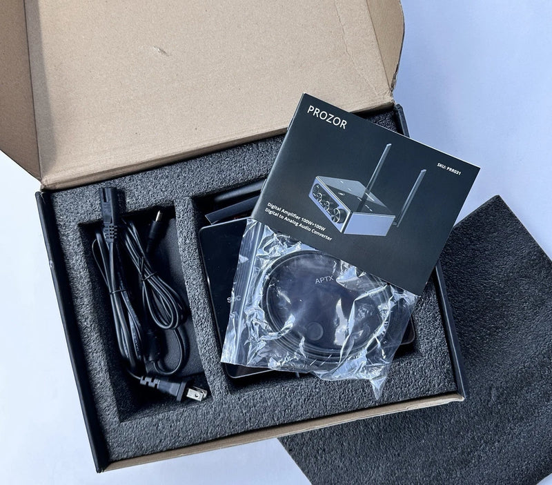 Digital audio amplifier kit with cables and instruction manual in foam-lined box