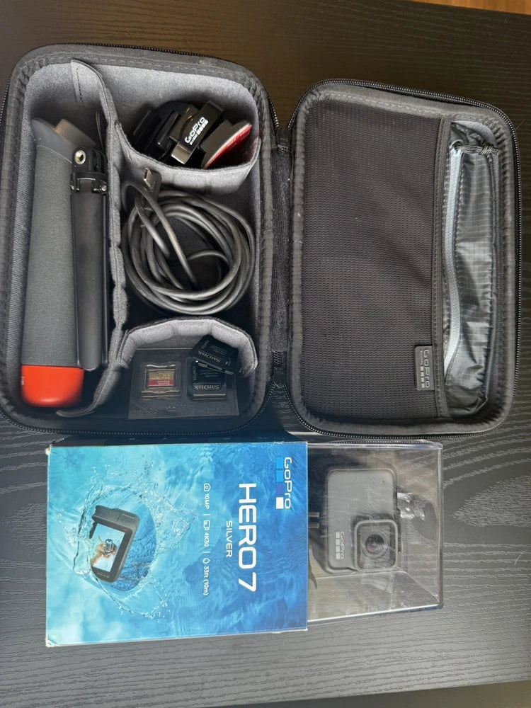 GoPro HERO7 accessory kit with gray zip case, cables, mounts, and spare camera housing