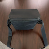 Black drone shoulder bag with zippered top and adjustable strap