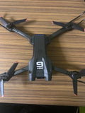 Mini RC quadcopter drone with four dark propellers and gray body