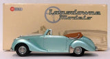 Metallic green 1:43 convertible model car with tan interior, side view.