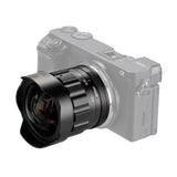 Wide angle camera lens with black barrel and front glass, mounted on silver body