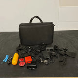 Black action camera case with camera, mounts, straps, and waterproof accessories