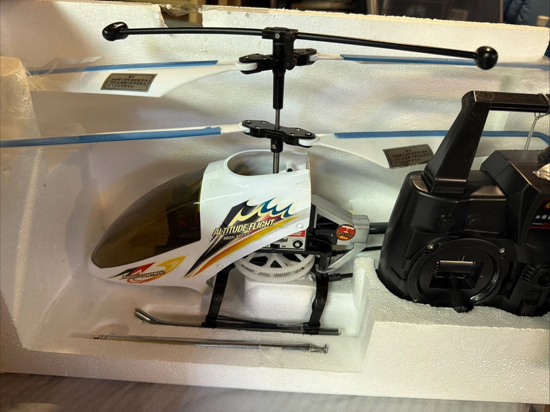 White RC helicopter drone with black rotors and black remote controller