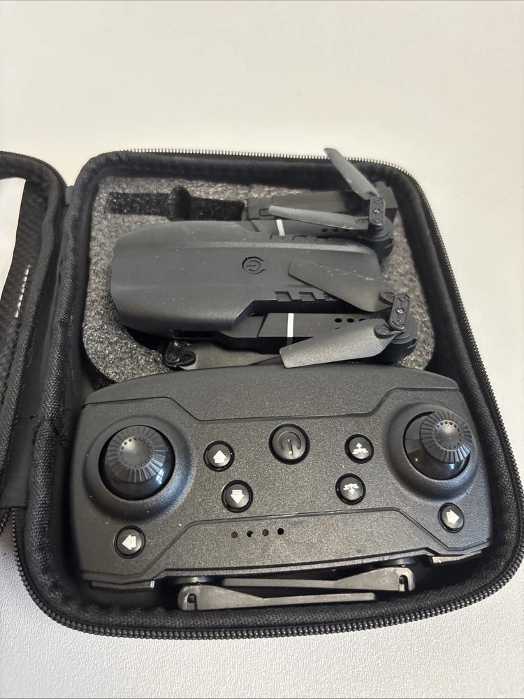 Folding drone in hard case with gray controller and compact remote buttons
