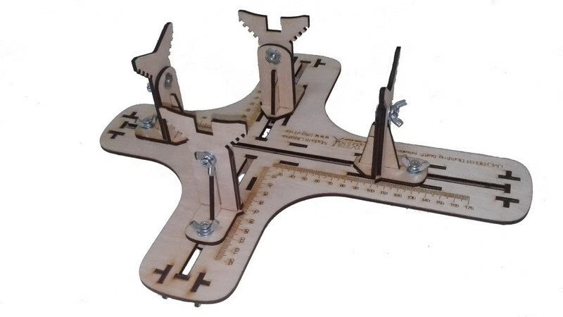 Airplane model building jig with metal clamps and peg arms on wood base
