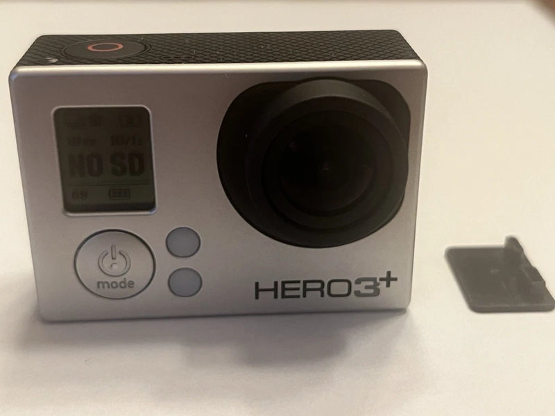 Silver action camera with large front lens and buttons, marked HERO3+