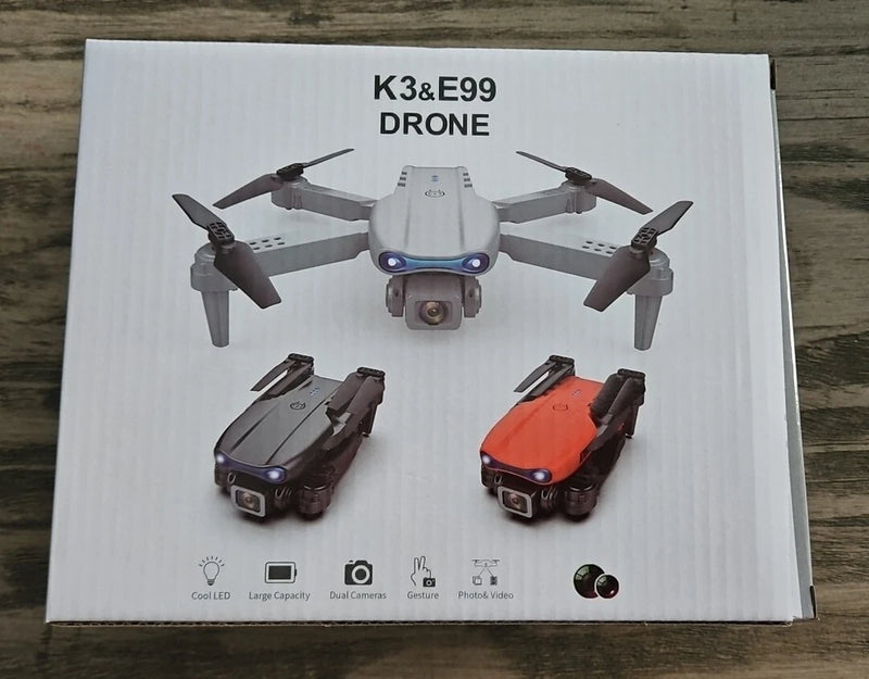 Folding dual-camera quadcopter drone, gray body with orange and black folded units